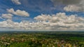 Fluffy white clouds in the blue sky over the green jungle. Royalty Free Stock Photo