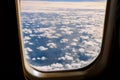 Fluffy white clouds and blue sky from airplane