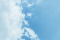 Fluffy white clouds on a clear blue background float in the sky. Royalty Free Stock Photo