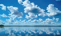 Fluffy white clouds drifting lazily across a brilliant blue sky Royalty Free Stock Photo