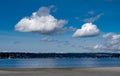 Fluffy white clouds over the beach on a lake Royalty Free Stock Photo