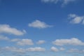 Fluffy white clouds in a sunny blue sky Royalty Free Stock Photo