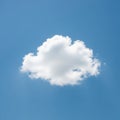 A fluffy, white cumulus cloud floats against a clear blue sky. The cloud has soft, rounded Royalty Free Stock Photo