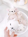 The fluffy white dolls in the basket