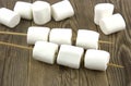 Fluffy white marshmallow on old wooden table