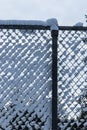 Fluffy white snow collected in a chain link fence Royalty Free Stock Photo