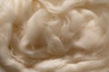 Fluffy wool texture in neutral beige color as background. Natural fiber in aesthetic sunlight Royalty Free Stock Photo