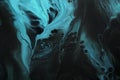 Fluid Art. Fluorescent blue waves on black background. Marble effect background or texture