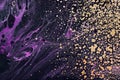 Fluid Art. Metallic gold spray and purple waves. Marble effect background or texture