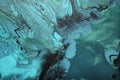 Fluid Art. Metallic Green and blue abstract waves with golden particles on black background. Marble effect background or Royalty Free Stock Photo