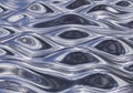 Fluid metallic waves ripple across a patterned surface, creating an illusion of shiny, liquid Royalty Free Stock Photo