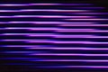 Fluorescent background. Blur curved texture. Futuristic light. Defocused neon pink purple blue color stripes in circles Royalty Free Stock Photo