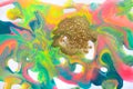 Fluorescent colorful liquid inks background with gold glitter particles. Marble imitation.