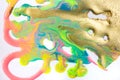 Fluorescent colorful liquid inks background with gold glitter particles. Marble imitation.