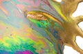 Fluorescent colorful liquid inks background with gold glitter particles. Marble imitation.