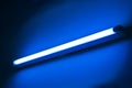 Fluorescent lamp shining on blue colored wall Royalty Free Stock Photo