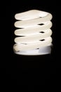 Fluorescent light bulb isolated on black background. Economical home lighting. Energy saving concept. Royalty Free Stock Photo