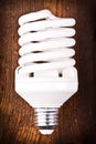 Fluorescent lightbulb on wood Royalty Free Stock Photo