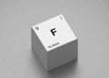 Fluorine element symbol, from periodic table on white cube on milimeter paper