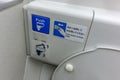 The flush button of a aircraft lavatory toilet. With English and Japanese instructions Royalty Free Stock Photo