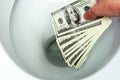 Flush money down the toilet Royalty Free Stock Photo