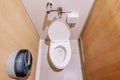 Flush toilet in public toilet. Light from fluorescent lamps,top view Royalty Free Stock Photo