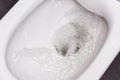 Flush toilet. Water flushes the toilet. The flow of water is clearly visible Royalty Free Stock Photo