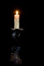 Flushed candle isolated in black and with the melted wax falling down in a chandelier