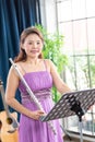 Flute classical instrument profestional player playing song. A young and elegant Asian woman plays the flute