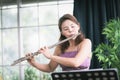 Flute classical instrument profestional player playing song. A young and elegant Asian woman plays the flute.