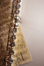 Flute and handwritten sheet music on white table top vertical