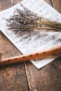 Flute with notes and lavender on the wooden table vertical Royalty Free Stock Photo