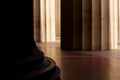 Fluted stone columns with light shining on them