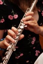 Flutist, young girl playing the flute, hands, fingers on keys closeup, children playing transverse side blow flute, detail shot