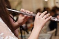 Flutist, young girl playing the flute, hands, fingers on keys closeup, children playing transverse side blow flute, detail shot, Royalty Free Stock Photo