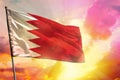 Fluttering Bahrain flag on beautiful colorful sunset or sunrise background. Success concept Royalty Free Stock Photo