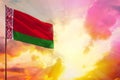 Fluttering Belarus flag in top left corner mockup with the space for your text on beautiful colorful sunset or sunrise background