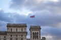 Fluttering Great britain flag in wind on flag pole on roof of the historical building in the London Royalty Free Stock Photo