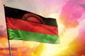 Fluttering Malawi flag on beautiful colorful sunset or sunrise background. Success concept