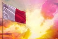 Fluttering Malta flag in top left corner mockup with the space for your text on beautiful colorful sunset or sunrise background