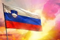 Fluttering Slovenia flag on beautiful colorful sunset or sunrise background. Success concept