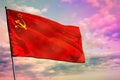 Fluttering Soviet Union SSSR, USSR flag on colorful cloudy sky background. Prosperity concept