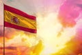 Fluttering Spain flag in top left corner mockup with the space for your text on beautiful colorful sunset or sunrise background