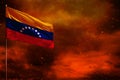 Fluttering Venezuela flag mockup with blank space for your text on crimson red sky with smoke pillars background. Troubles concept