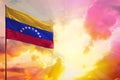 Fluttering Venezuela flag in top left corner mockup with the space for your text on beautiful colorful sunset or sunrise