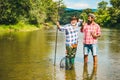 Fly angler on the river. Fishing in river. Fishing in river. Fly fisherman using fly fishing rod in beautiful river Royalty Free Stock Photo