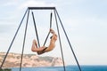 Fly-dance yoga poses in a hammock with mountains view. Harmony with nature Royalty Free Stock Photo