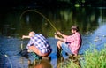 Fly fish hobby of men. retirement fishery. happy fishermen friendship. retired father and mature bearded son. big game Royalty Free Stock Photo