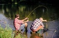 fly fish hobby of men. retirement fishery. happy fishermen friendship. retired father and mature bearded son. big game Royalty Free Stock Photo