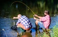 Fly fish hobby of men. retirement fishery. retired father and mature bearded son. Two male friends fishing together Royalty Free Stock Photo